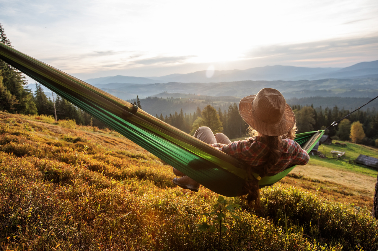 white-woman-in-hammock-looking-at-mountains