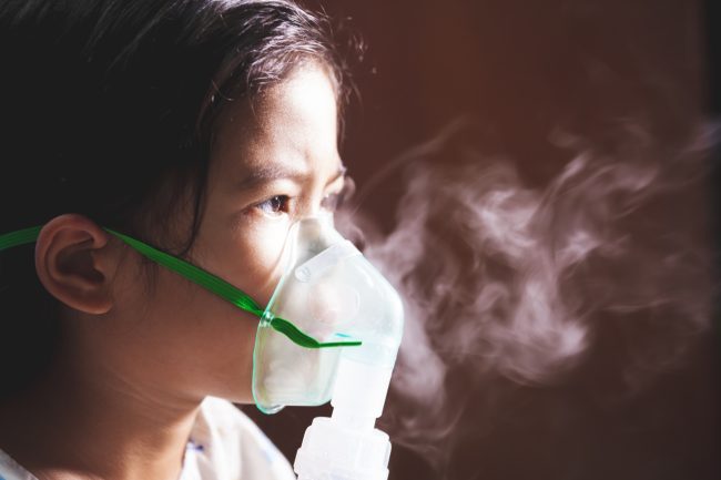 Asian child girl has asthma or pneumonia disease and need nebulization by get inhaler mask on her face