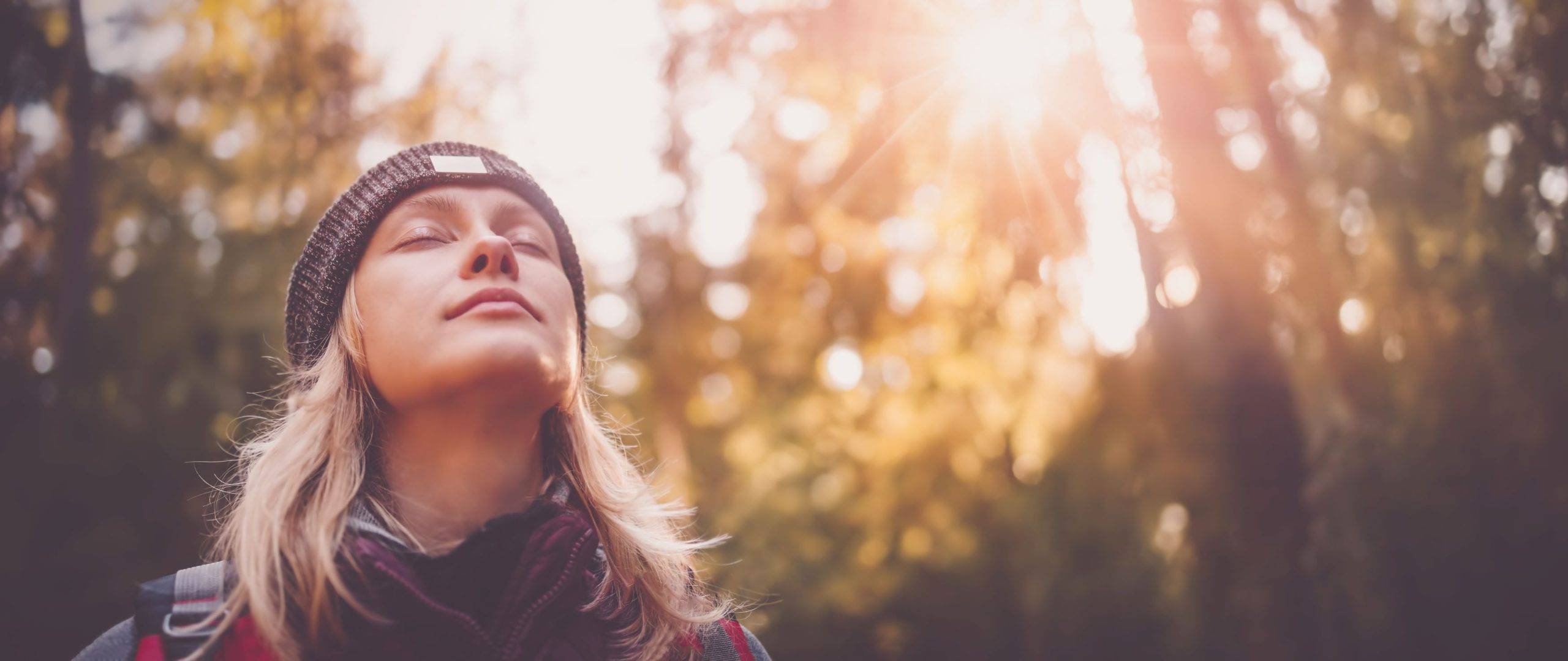 a woman breathing in clean air in nature