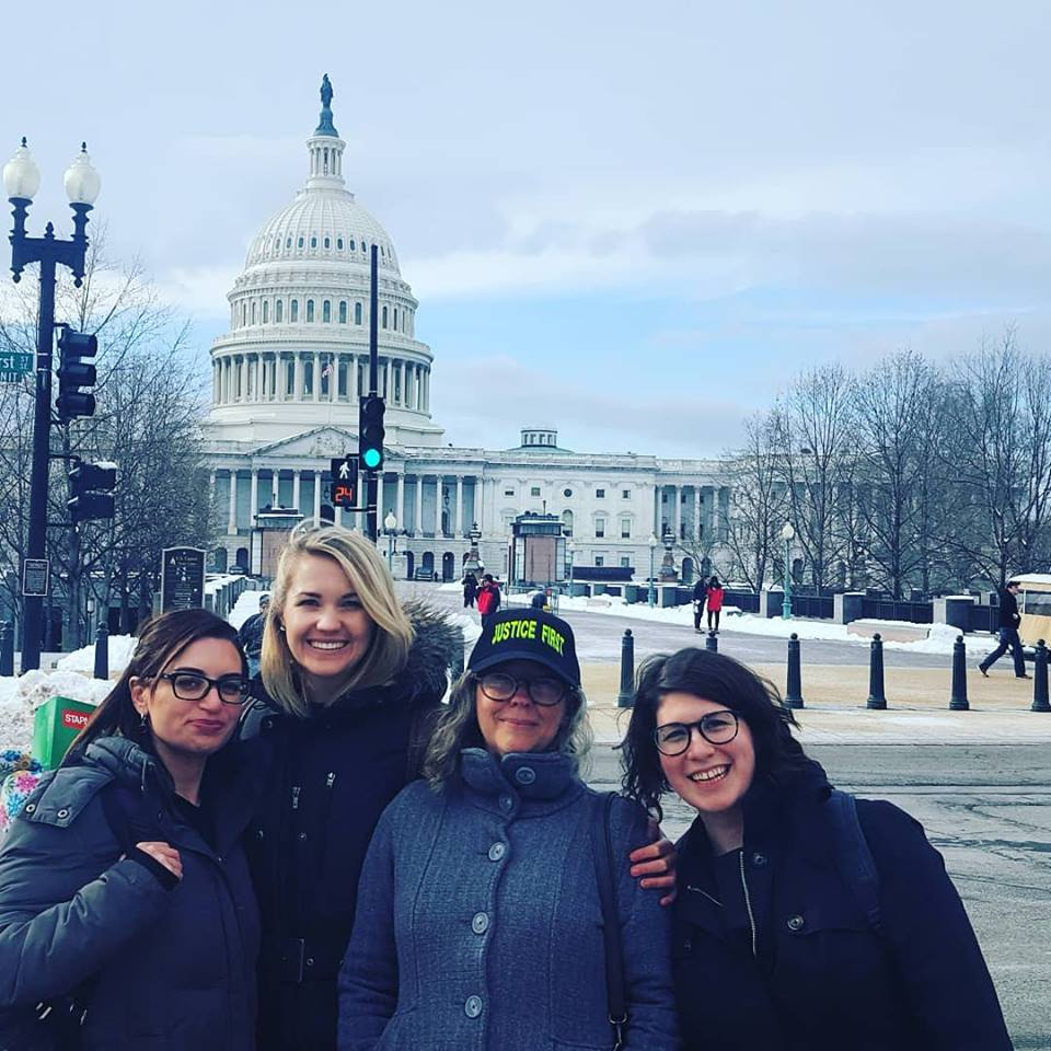 Four women, Carina Daniels, Rita Frost, Danna Smith, and Rachel Weber, in front of the Capitol Building in Washington DC