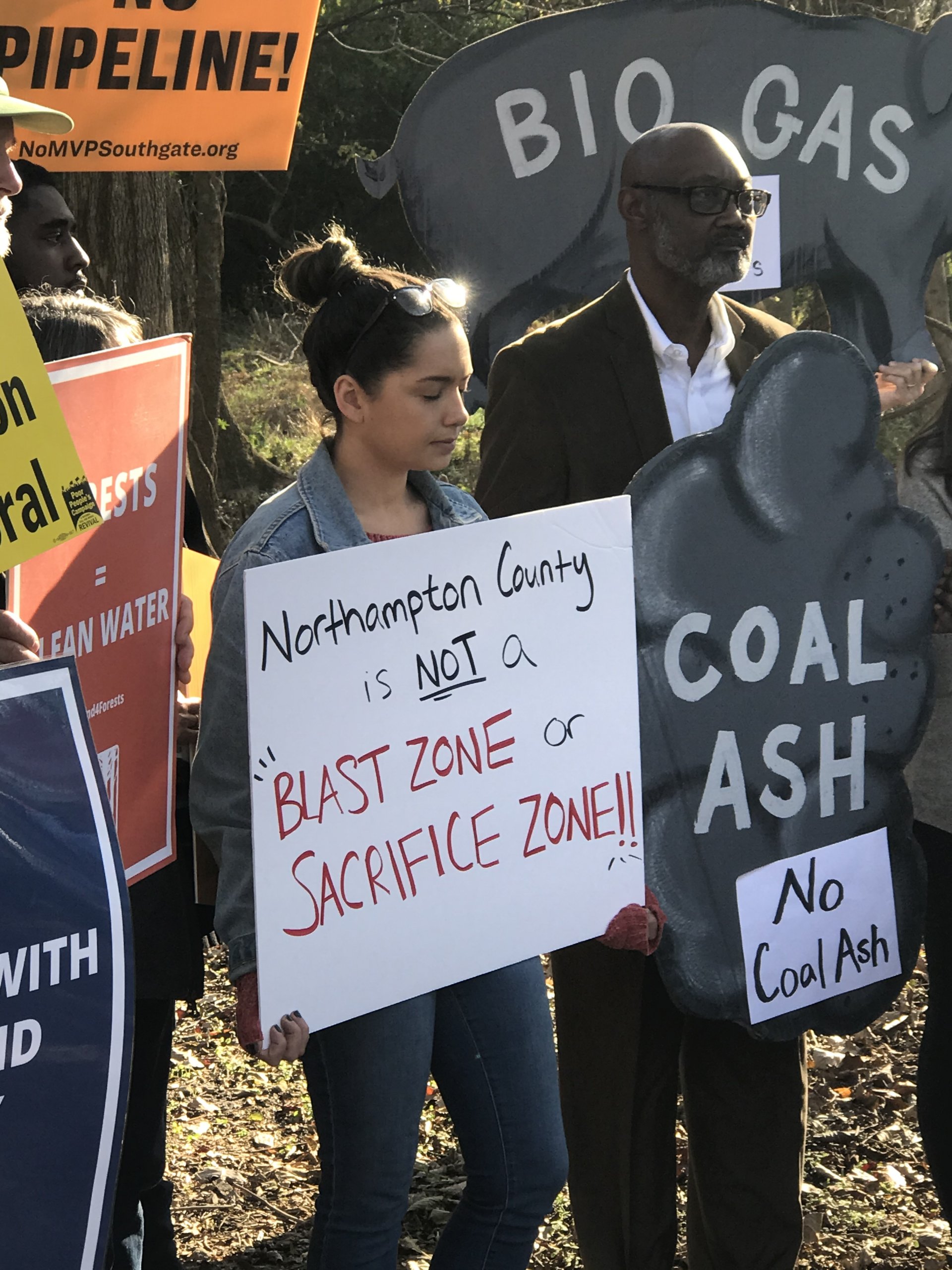 Rachel Velez of Clean Water for North Carolina holds a sign that reads