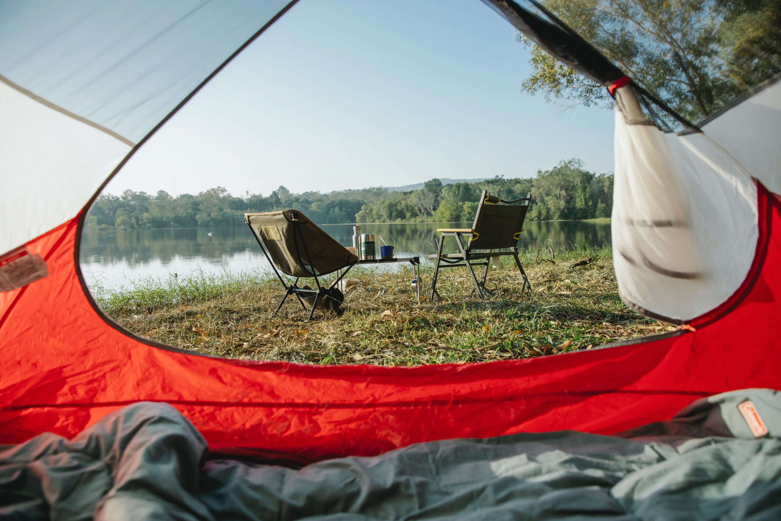a view of nature from inside an orange tent - landowners can rent their land to campers