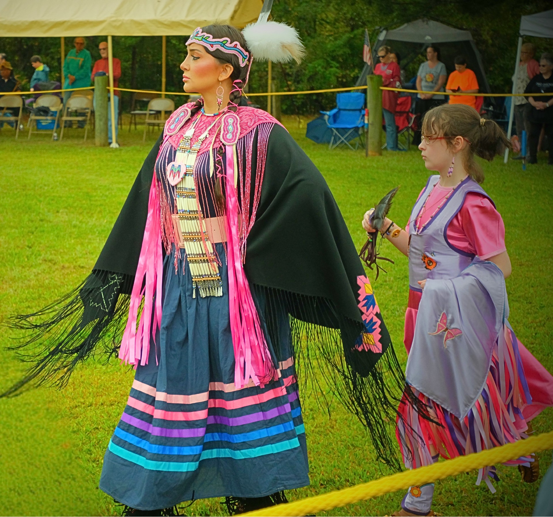 native american woman in ceremonial dress at powwow